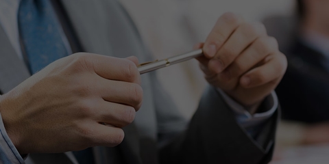 business man holding pencil