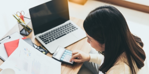 Woman doing finances on a calculator