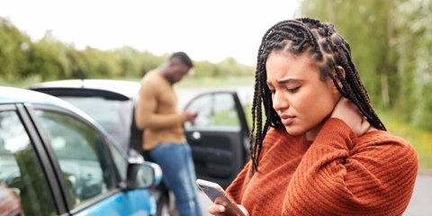 Woman holding her neck after a car accident